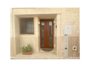 a building with a door and a plant in front of it at House Aurora in Fasano +7 photos