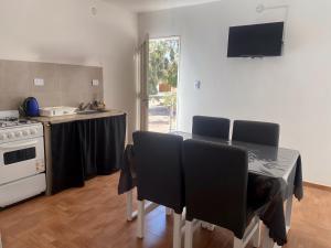 a kitchen with a table with chairs and a stove at Departamentos Turísticos Cloe 2 in Fiambalá