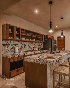 a kitchen with a large marble counter top at Casa Junab - Casa-House in El Cuyo