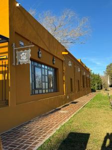 un edificio marrón con ventanas laterales en Como Entonces Casa, en Uribelarrea