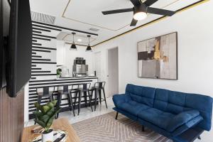 a living room with a blue couch and a kitchen at Doral Beach in Tampa