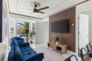 a living room with a blue couch and a tv at Doral Beach in Tampa
