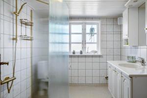 a white bathroom with a sink and a window at 266-Harboore-Strandvejen-177-A in Harboør +69 photos