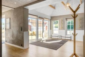 a living room with a vaulted ceiling and windows at 266-Harboore-Strandvejen-177-A in Harboør