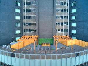 a view of a building with two benches and tables at Boho, Walk East Village, Downtown, Free Parking in Des Moines