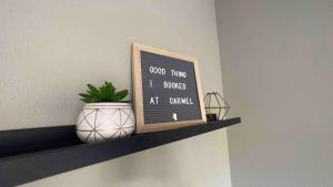 a chalkboard on a shelf with a plant on it at Exclusive, Pool, Massage Chair, Jordan Creek in West Des Moines