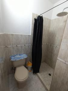 a bathroom with a shower with a toilet and a shower curtain at Mini apartamento 2 habitaciones in Ciudad Guayana +10 photos