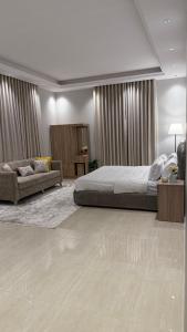 a large bedroom with a bed and a couch at DreeM in Al Madinah
