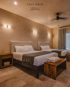 a hotel room with two beds in a room at Casa Junab - Casa-House in El Cuyo