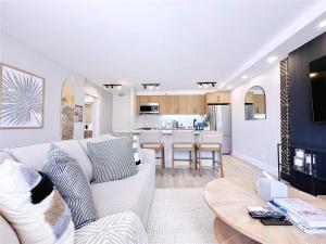 a living room with a white couch and a table at Huge patio I Luxury 1BR Banyan I Washer I Free park I 5' Beach in Honolulu