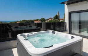 a hot tub on the balcony of a building at Cozy Apartment In Tar With Wifi in Frata +29 photos