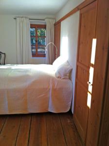a bedroom with a bed and a wooden floor at Cottage am Waldrand gelegen in Feldkirchen in Kärnten