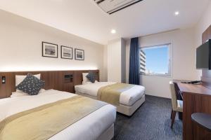 Ένα ή περισσότερα κρεβάτια σε δωμάτιο στο HOTEL MYSTAYS Hakodate Station