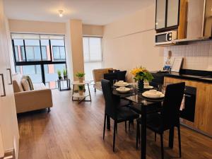 a kitchen and living room with a table and chairs at Monterrico Polo Aparts 9 - Frente Embajada USA in Lima