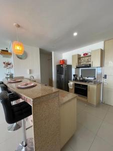 a kitchen with a large island in a room at Apartamento salida al Mar Santa Marta in Santa Marta +30 photos