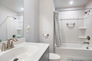 a white bathroom with a sink and a toilet at New Charming Surburban Retreat 12 mins to Lakepoint in Acworth +41 photos