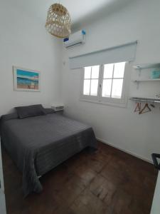 Ένα ή περισσότερα κρεβάτια σε δωμάτιο στο Precioso Depto en el Centro de Concordia