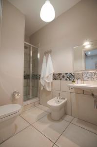 a bathroom with a sink and a toilet and a shower at Le case del Duca in Ioppolo Giancaxio