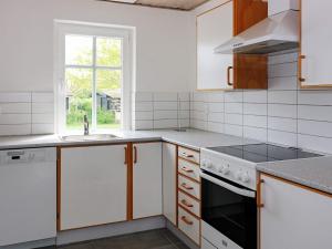 a kitchen with white appliances and a window at 6 person holiday home in Hadsund-By Traum in Hadsund +10 photos