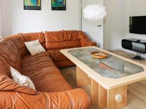 a living room with a couch and a table at 6 person holiday home in Hadsund-By Traum in Hadsund