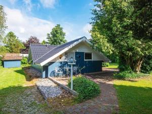 a small blue shed with a blue door at Secluded Oasis by Kvie Lake-By Traum in Ansager +28 photos