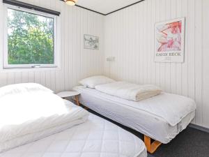 two beds in a room with a window at 6 person holiday home in Hals-By Traum in Hals