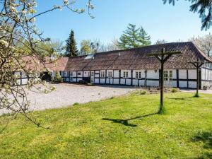 un grande edificio con una croce nell'erba di 7 person holiday home in Grenaa a Grenå