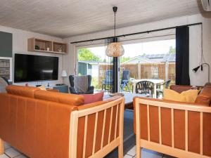 a living room with two couches and a television at 10 person holiday home in Ørsted in Ørsted