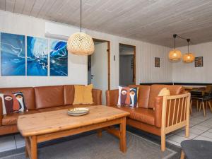 a living room with a couch and a table at 10 person holiday home in Ørsted in Ørsted