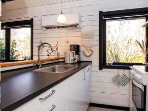 a kitchen with a sink and two windows at 4 person holiday home in Nibe-By Traum in Nibe