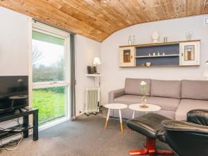 a living room with a couch and a table at 4 person holiday home in Grindsted-By Traum in Grindsted