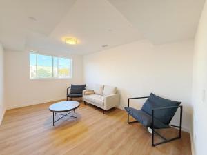 a living room with a couch and a table and chairs at Double Beds Room with Private Bathroom in Los Angeles