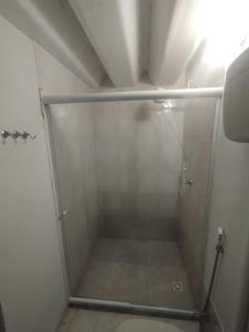 a shower stall in a bathroom with a toilet at Loft Lagoa Areal in Araruama