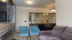 a living room with a couch and chairs and a table at Apartamento próx praia in Balneário Camboriú +21 photos