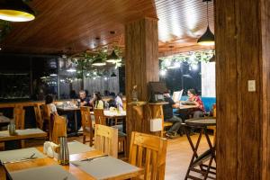 a group of people sitting at tables in a restaurant at Velvet Sunrise Hotel in Machu Picchu