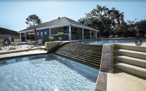 a swimming pool in front of a house at Enchanted April Lake House 3 Bed 2 Bath in Montgomery