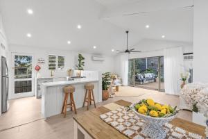 a kitchen with a bowl of fruit on a table at Chic Coastal Retreat in Ocean Grove