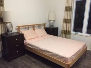 a bedroom with a bed with two night stands and two lamps at Orchard Cottage - Honeycrisp in Aurora