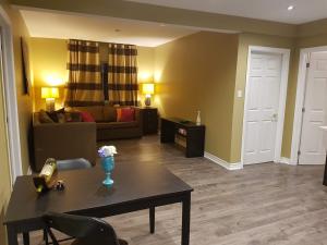 a living room with a table and a couch at Orchard Cottage - Honeycrisp in Aurora