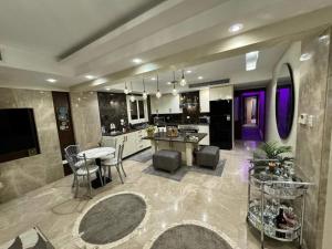 a large kitchen with a table and chairs in it at Samar Adel in Cairo