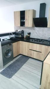 a kitchen with a sink and a washing machine at Appartement s1 in Ez Zahra
