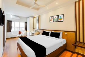 a bedroom with a large bed in a room at Townhouse Oak Kodambakkam Formerly Cine City in Chennai