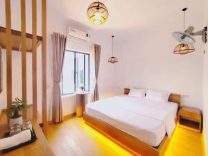 a bedroom with a white bed and a window at Sol Flow Retreat in Nguyên Ngoại +34 photos