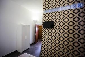 Televízia a/alebo spoločenská miestnosť v ubytovaní Casa Retro'