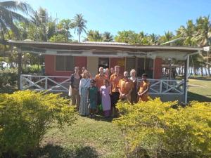 a group of people standing in front of a house at Nenas Homestay 