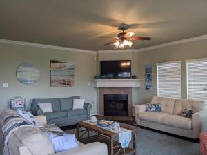 a living room with two couches and a fireplace at Portofino House - Seabrook - 3 Bed 2 Bath Hot Tub in Seabrook