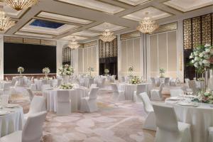 a banquet hall with white tables and white chairs at The St. Regis Singapore in Singapore +77 photos
