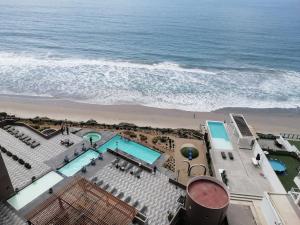 an aerial view of a pool and the beach at Betty's Apartment in Tijuana