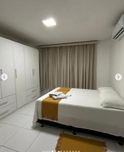 En eller flere senge i et værelse på Casa 3 quartos praia de sao jose