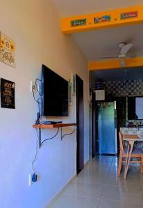 a television on a shelf on a wall in a room at Escapada do Sonho in Lençóis
